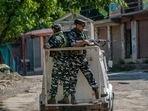 Paramilitary soldiers stand guard on an armored vehicle as they move towards the site of a gunfight in Pulwama, south of Srinagar, in Kashmir, last week. 