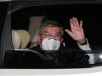 International Olympic Committee (IOC) President Thomas Bach waves from the vehicle to media upon his arrival an accommodation Thursday, July 8, 2021, in Tokyo.