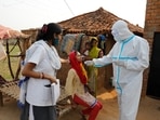 Health workers take a nasal swab of a woman to test for Covid-19 in Jamsoti village, Uttar Pradesh state, India, June 8, 2021. 
