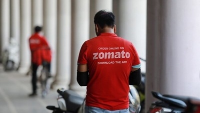 A delivery worker of Zomato, an Indian food-delivery startup, waits to collect an order from a restaurant in New Delhi. (File photo)