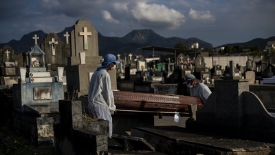 Cemetery workers carrying a coffin at the Inhauma cemetery in Rio de Janeiro, Brazil on June 18. The Covid-19 toll is three times the number of people killed in traffic accidents around the globe every year. It is about equal to the population of Los Angeles or the nation of Georgia. It is equivalent to more than half of Hong Kong or close to 50% of New York City. (Bruna Prado / AP)