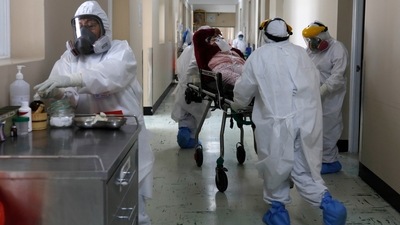 Medical staff transporting a Covid-19 patient at the Honorio Delgado Hospital in Arequipa, Peru on June 25. it’s taken just 82 days for the latest million deaths, compared to 92 days for the previous million, according to data from Johns Hopkins University. (Guadalupe Pardo / AP)