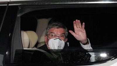 International Olympic Committee (IOC) President Thomas Bach waves from the vehicle to media upon his arrival an accommodation Thursday, July 8, 2021, in Tokyo. (AP) International Olympic Committee (IOC) President Thomas Bach waves from the vehicle to media upon his arrival an accommodation Thursday, July 8, 2021, in Tokyo. (AP)