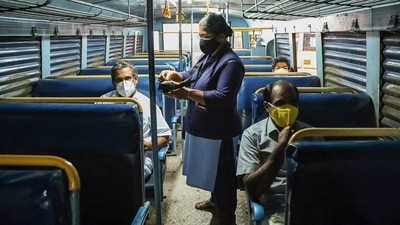 A lady conductor issues tickets to customer during start of Kerala RTC services in Kozhikode. (PTI) A lady conductor issues tickets to customer during start of Kerala RTC services in Kozhikode. (PTI)