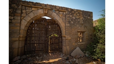 The Wadhwan cinema isn’t even a structure. It’s a stone wall, a large wooden gate and a small ticket window leading onto a large ground. It breaks his heart, Chaturvedi says, that so little of those times was preserved.  (Photo by Hemant Chaturvedi)