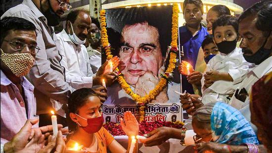 Fans hold candles to pay homage to actor Dilip Kumar, in Bhopal, Wednesday. (PTI) Fans hold candles to pay homage to actor Dilip Kumar, in Bhopal, Wednesday. (PTI)