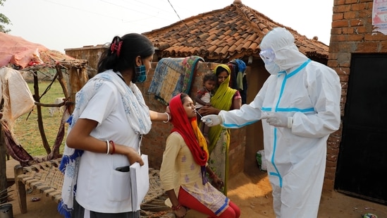 Health workers take a nasal swab of a woman to test for Covid-19 in Jamsoti village, Uttar Pradesh state, India, June 8, 2021. (AP Photo/Rajesh Kumar Singh) Health workers take a nasal swab of a woman to test for Covid-19 in Jamsoti village, Uttar Pradesh state, India, June 8, 2021. (AP Photo/Rajesh Kumar Singh)