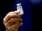 Former health minister Harsh Vardhan holds a dose of Bharat Biotech's Covid-19 vaccine called COVAXIN, during a vaccination campaign at All India Institute of Medical Sciences (AIIMS) hospital in New Delhi.