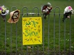 Flowers and a placard are seen on a fence at a memorial site at the Clapham Common Bandstand, following the kidnap and murder of Sarah Everard, in London. 