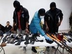 Weaponry, mobile phones, passports and other items along with suspects in the assassination of President Jovenel Moise.(Reuters)