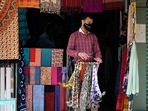 A vendor wearing a facemask as a preventive measure against the spread of the Covid-19 coronavirus, opens his shop at a market in New Delhi. A vendor wearing a facemask as a preventive measure against the spread of the Covid-19 coronavirus, opens his shop at a market in New Delhi.