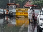A policeman checks vehicles amid a mild shower at Connaught Place, in New Delhi, Wednesday.(PTI) A policeman checks vehicles amid a mild shower at Connaught Place, in New Delhi, Wednesday.(PTI)