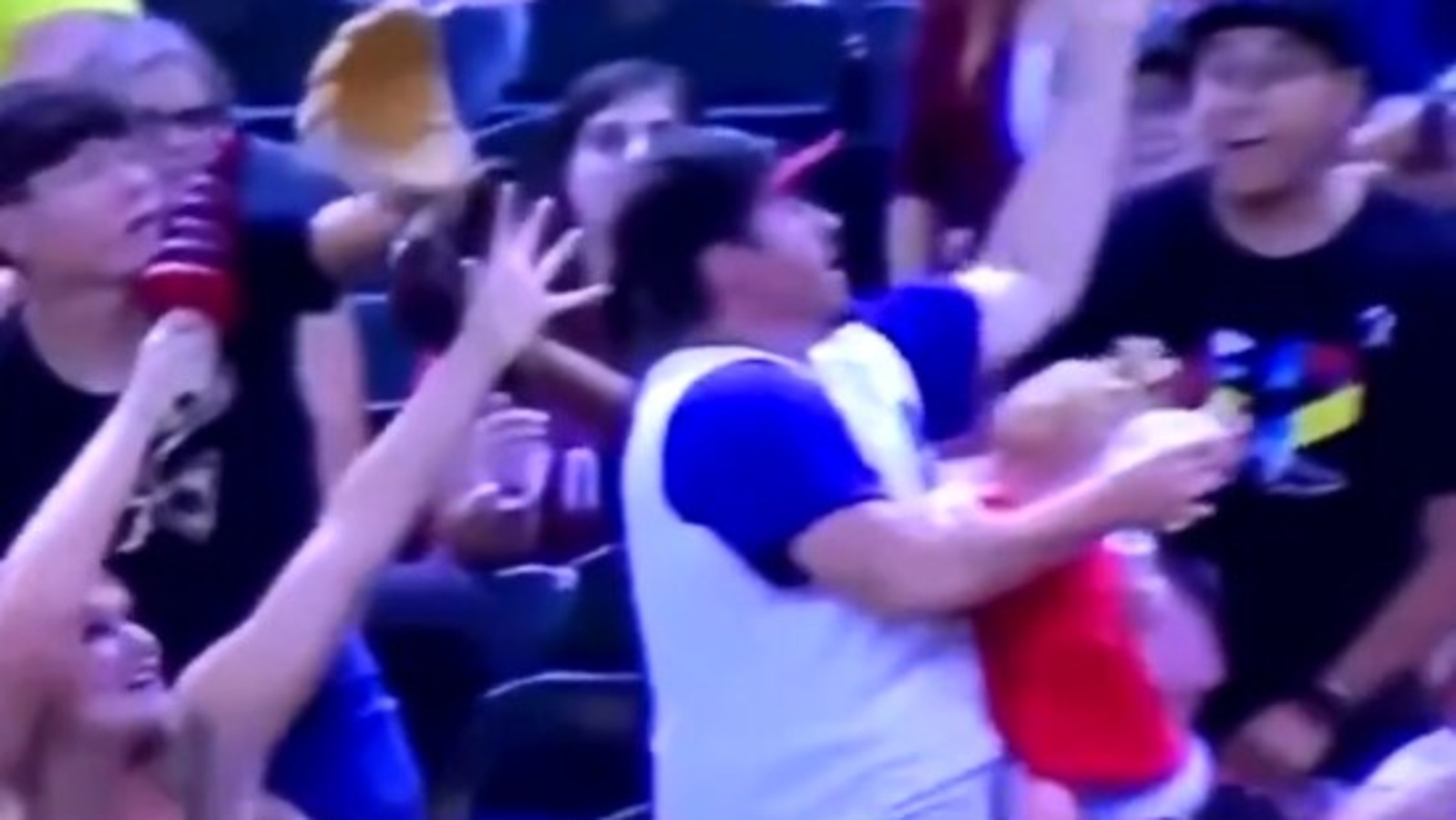 Dad juggles baby and ball at baseball game, viral video sparks mixed