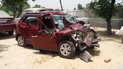 The driver tried to overtake a truck, but ended up crashing the car into the rear of another truck near Sangrur in the wee hours of Friday. (HT Photo)