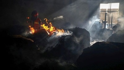 A firefighter tries to extinguish fire inside the building after a fire broke out at a factory named Hashem Foods Ltd. in Rupganj of Narayanganj district, on the outskirts of Dhaka, Bangladesh. (REUTERS)