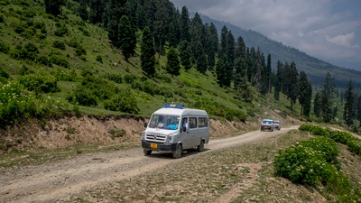A team of healthcare workers move in vehicles during a vaccination drive in Tosamaidan, southwest of Srinagar on June 21. The rumors are plentiful. Still, Kashmir has done better than the rest of India. Scores of health workers like Farid have fully vaccinated over 9% of the eligible people among the region's 14 million population. (Dar Yasin / AP)