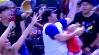 The image shows the dad juggling between his baby and a ball. (Screengrab)