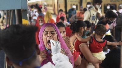 Mumbai: A health worker takes swab sample of a passenger for COVID-19 test, at a railway station in Mumbai, Friday, July 9, 2021. (PTI) Mumbai: A health worker takes swab sample of a passenger for COVID-19 test, at a railway station in Mumbai, Friday, July 9, 2021. (PTI)