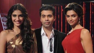 Sonam Kapoor and Deepika Padukone pose with Karan Johar on Koffee with Karan. Sonam Kapoor and Deepika Padukone pose with Karan Johar on Koffee with Karan.