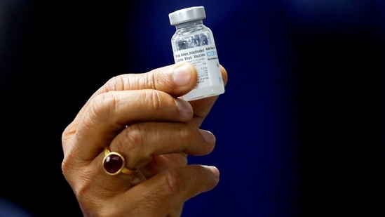 Former health minister Harsh Vardhan holds a dose of Bharat Biotech's Covid-19 vaccine called COVAXIN, during a vaccination campaign at All India Institute of Medical Sciences (AIIMS) hospital in New Delhi.(Reuters)