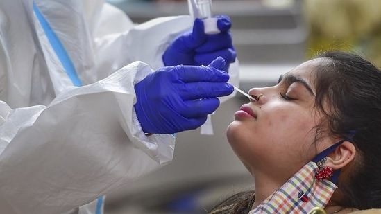 A health worker collects a swab sample of a passenger for a Covid-19 test at a railway station in Kerala on July 7 (PTI)