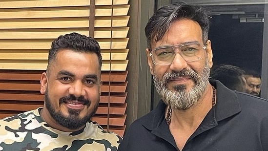 Ajay Devgn poses with his bodyguard Gautam.