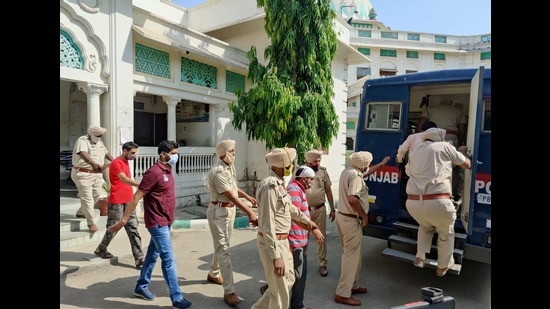 The accused Dera Sacha Sauda followers being taken out of a Faridkot court in May. (HT Photo)