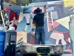 Roberto Marquez used his art to turn Surfside's pain into hope and resilience. (AP Photo/ Stacey Plaisance) Roberto Marquez used his art to turn Surfside's pain into hope and resilience. (AP Photo/ Stacey Plaisance)