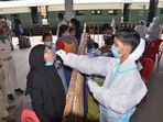 Passengers give their swab samples for Covid-19 tests after arriving at the railway station in Ranchi.