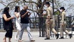Police personnel asking a family to don masks and follow the Covid-19 protocol at the Ridge in Shimla.(Deepak Sansta/HT) Police personnel asking a family to don masks and follow the Covid-19 protocol at the Ridge in Shimla.(Deepak Sansta/HT)