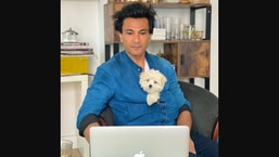 The image shows Vikas Khanna with his dog names Plum.