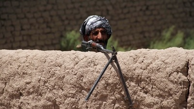 A former Mujahideen keeps watch at a check post as he holds a weapon to support Afghan forces in their fight against Taliban, on the outskirts of Herat province, Afghanistan July 10, 2021. (Reuters)