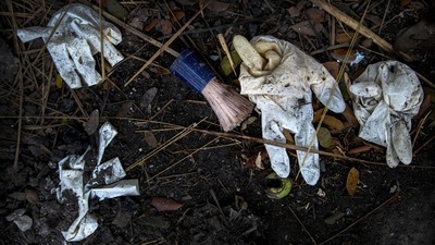 A shaving brush and gloves of deceased Covid-19 victims and their relatives lie in a cremation ground in Guwahati on July 2. Covid-18 has claimed over 407,000 lives in India as of July 10 according to government figures. (Anupam Nath / AP) A shaving brush and gloves of deceased Covid-19 victims and their relatives lie in a cremation ground in Guwahati on July 2. Covid-18 has claimed over 407,000 lives in India as of July 10 according to government figures. (Anupam Nath / AP)