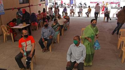 People wait outside Covid 19 vaccination center to get vaccine in Pune. (Ravindra Joshi/HT PHOTO)