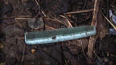 A comb belonging to a deceased Covid-19 victim lies in a cremation ground in Guwahati on July 2. The scattered belongings perhaps, also reflects the grim fears grieving people — shaken by the deaths of their loved ones. (Anupam Nath / AP) A comb belonging to a deceased Covid-19 victim lies in a cremation ground in Guwahati on July 2. The scattered belongings perhaps, also reflects the grim fears grieving people — shaken by the deaths of their loved ones. (Anupam Nath / AP)