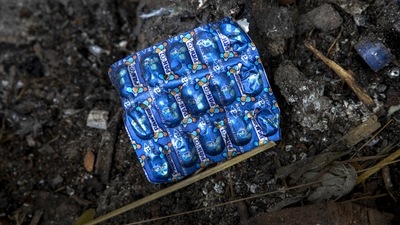 An empty wraper of medicine used by a deceased Covid-19 victim lies in a cremation ground in Guwahati on July 2. (Anupam Nath / AP) An empty wraper of medicine used by a deceased Covid-19 victim lies in a cremation ground in Guwahati on July 2. (Anupam Nath / AP)