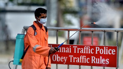 A health worker sprays disinfectants in a parking area in Chennai (PTI) A health worker sprays disinfectants in a parking area in Chennai (PTI)