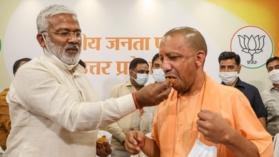 Uttar Pradesh Chief Minister Yogi Adityanath with BJP state President Swatantra Dev Singh celebrates victory in UP Block Panchayat Elections, at party office in Lucknow, Saturday, July 10, 2021. (PTI) Uttar Pradesh Chief Minister Yogi Adityanath with BJP state President Swatantra Dev Singh celebrates victory in UP Block Panchayat Elections, at party office in Lucknow, Saturday, July 10, 2021. (PTI)