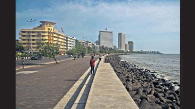 A solitary walker takes photographs of the sea at Marine Drive on a weekday evening. (Pratik Chorge / HT) A solitary walker takes photographs of the sea at Marine Drive on a weekday evening. (Pratik Chorge / HT)