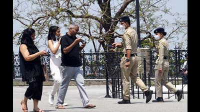 Police personnel asking a family to don masks and follow the Covid-19 protocol at the Ridge in Shimla on Saturday. (Deepak Sansta/HT) Police personnel asking a family to don masks and follow the Covid-19 protocol at the Ridge in Shimla on Saturday. (Deepak Sansta/HT)
