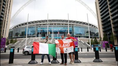 England fans and an Italy fan pose with flags outside Wembley stadium ahead of the Euro 2020 final. (REUTERS) England fans and an Italy fan pose with flags outside Wembley stadium ahead of the Euro 2020 final. (REUTERS)