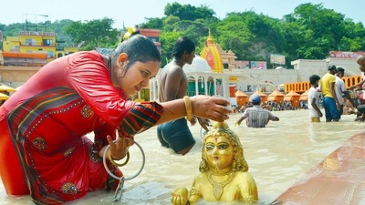 A devotee pours water over an idol depicting Ganga Snan, in Haridwar on Friday. (ANI)