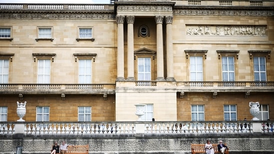 People sit together in The Garden of Buckingham Palace, during a preview day before it opens to the public, in London, Britain, July 8, 2021. The opening of the state rooms to the public during the summer months, which has taken place since 1993, has also not been able to go ahead.(REUTERS)