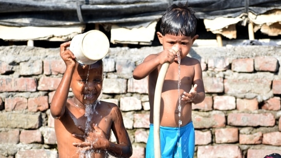 Children take bath on a hot summer day, in New Delhi on Saturday. (ANI Photo)