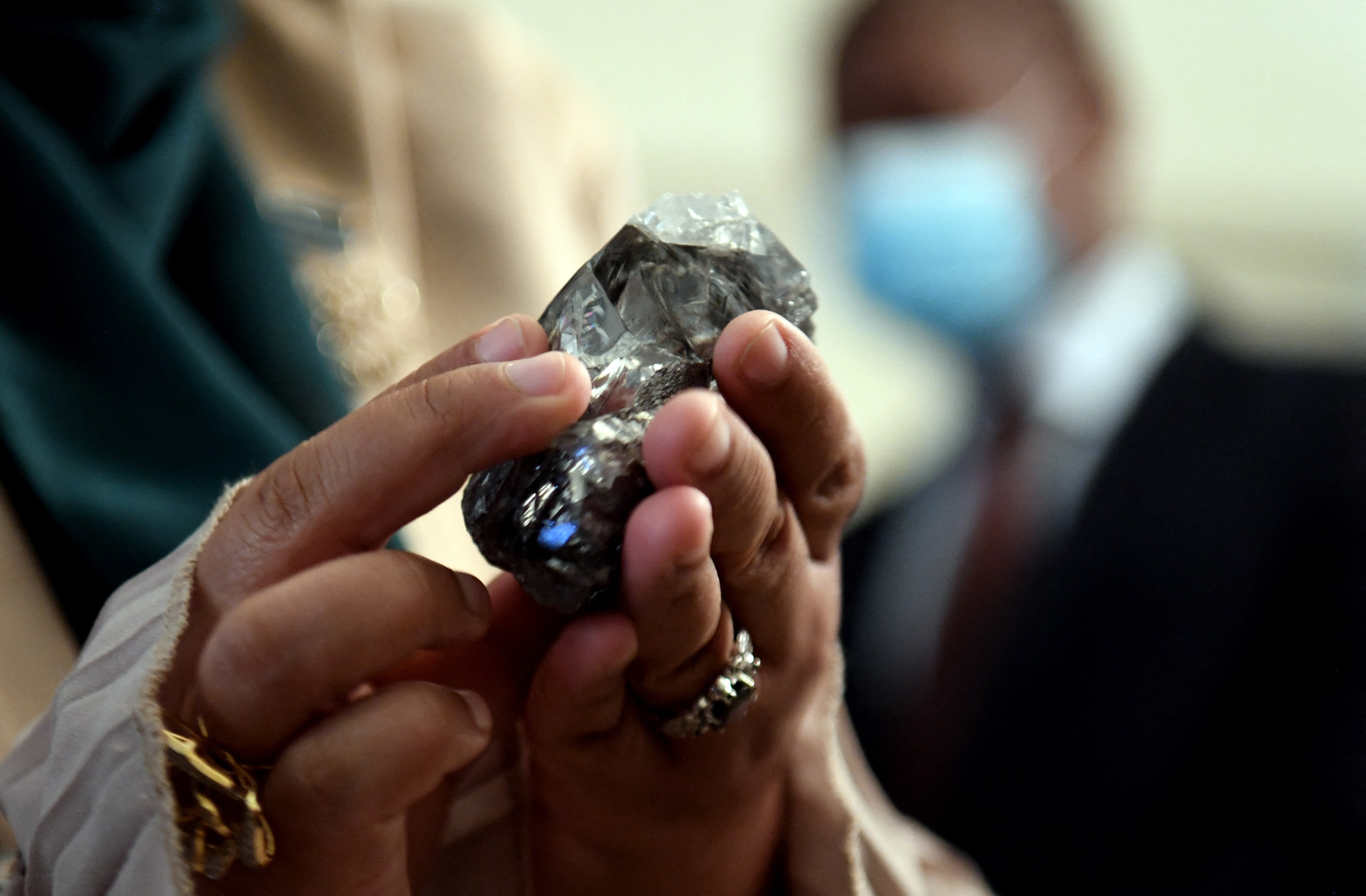 A member of the Botswana cabinet holds a 1,174-carat diamond in Gaborone, Botswana that Lucara Diamonds Corp. unearthed.(AFP)