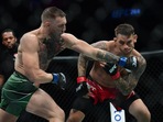 Conor McGregor moves in for a hit against Dustin Poirier during UFC 264 at T-Mobile Arena. 