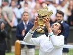 Serbia's Novak Djokovic celebrates with the trophy after winning his final match against Italy's Matteo Berrettini.