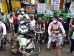 Trinamul Congress supporters pull a scooty on a tri-cart and others ride bicycles during a demonstrative protest against fuel price hikes at a petrol pump, in Kolkata on Saturday. (ANI Photo) Trinamul Congress supporters pull a scooty on a tri-cart and others ride bicycles during a demonstrative protest against fuel price hikes at a petrol pump, in Kolkata on Saturday. (ANI Photo)