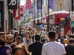 Pedestrians, some wearing face coverings due to Covid-19, walk past shops on Oxford Street in central London. Pedestrians, some wearing face coverings due to Covid-19, walk past shops on Oxford Street in central London.