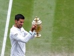 Serbia's Novak Djokovic shows off the winners trophy to the crowd as he walks around Centre Court after defeating Italy's Matteo Berrettini in the men's singles final on day thirteen of the Wimbledon Tennis Championships in London, Sunday, July 11, 2021. (Pete Nichols/Pool Via AP)(AP) Serbia's Novak Djokovic shows off the winners trophy to the crowd as he walks around Centre Court after defeating Italy's Matteo Berrettini in the men's singles final on day thirteen of the Wimbledon Tennis Championships in London, Sunday, July 11, 2021. (Pete Nichols/Pool Via AP)(AP)